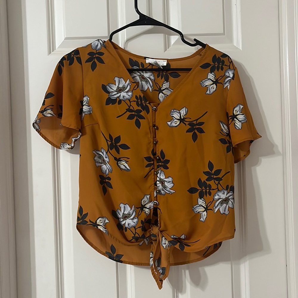 Orange blouse with white flowers.